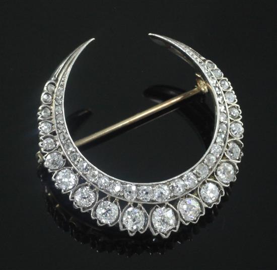 A Victorian gold, silver and diamond double crescent brooch, 33mm.